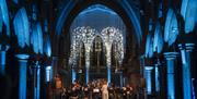 A cathedral lit up with blue light
