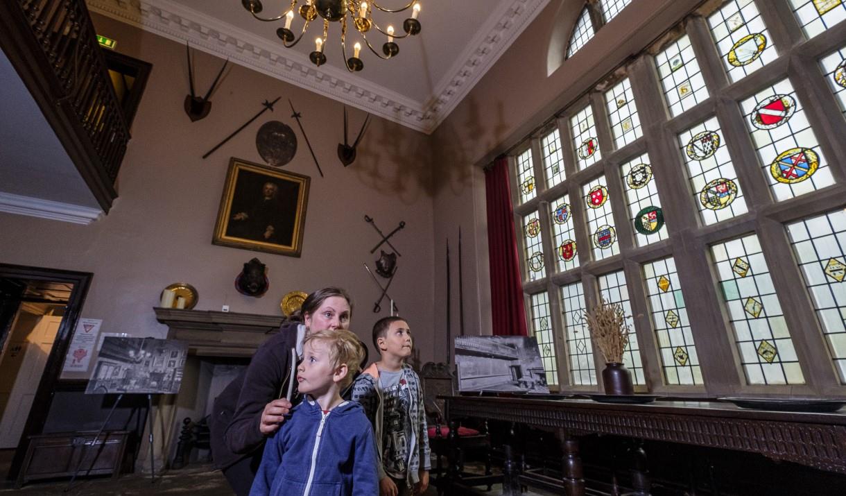 People looking at stained glass windows
