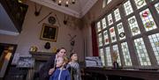 People looking at stained glass windows