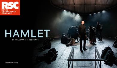A picture of actors on a bare stage