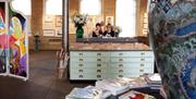 1853 Gallery, visitors browsing postcards