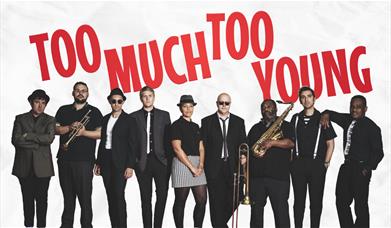 A picture of a 9-piece ska band, dressed in black and white
