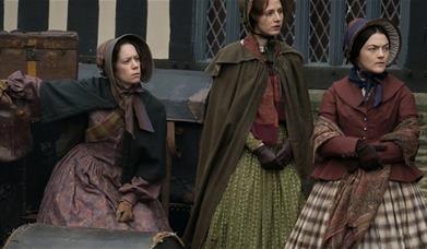 3 women in period clothing