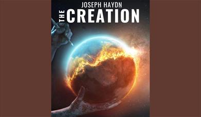 A poster depicting a pair of hands "creating" the world